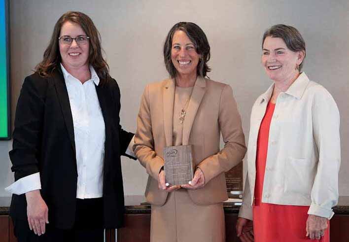 Laura Breifer holding a clear ASPA award